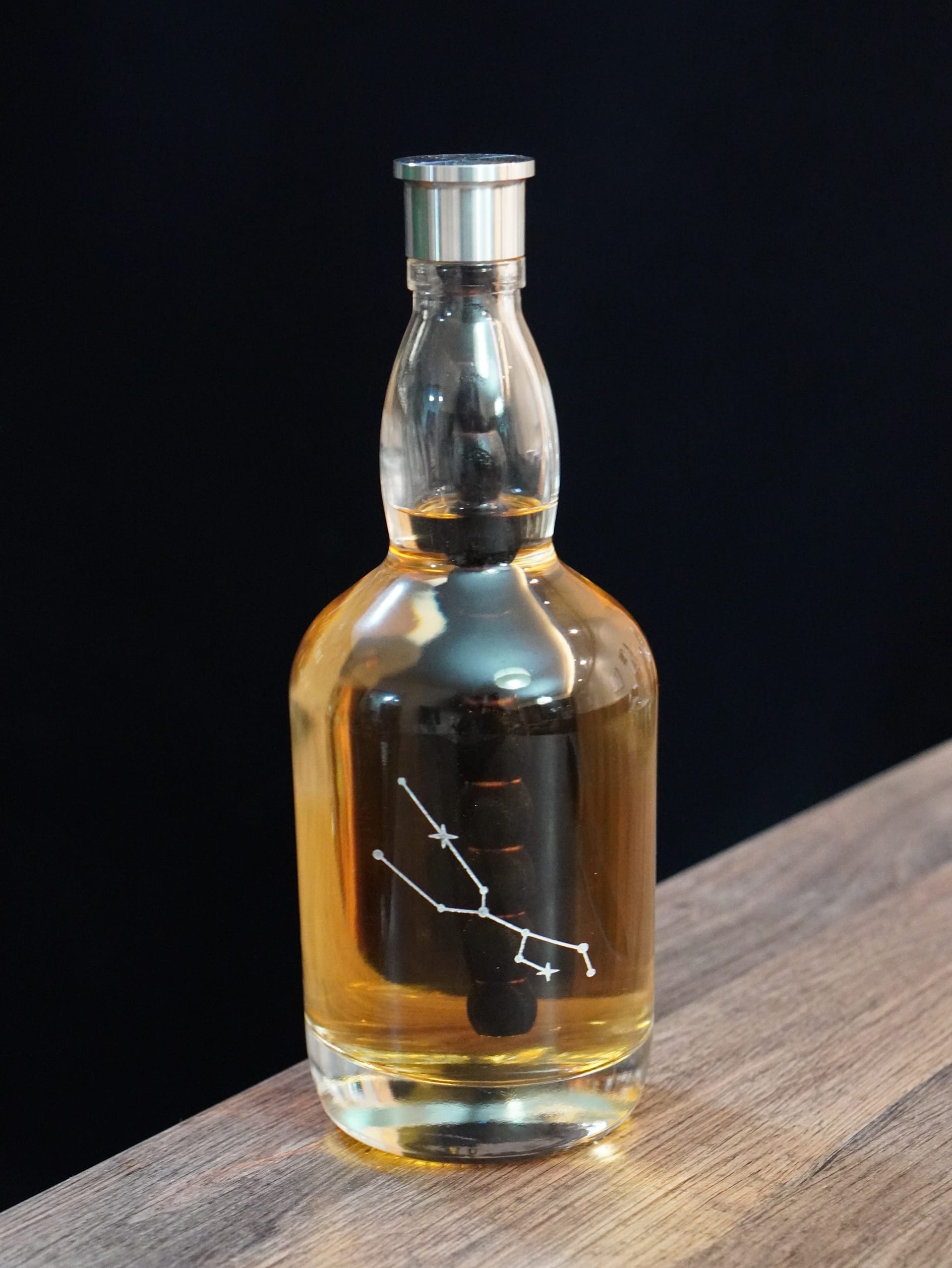 Aging Bottle filled with spirits on a wooden table