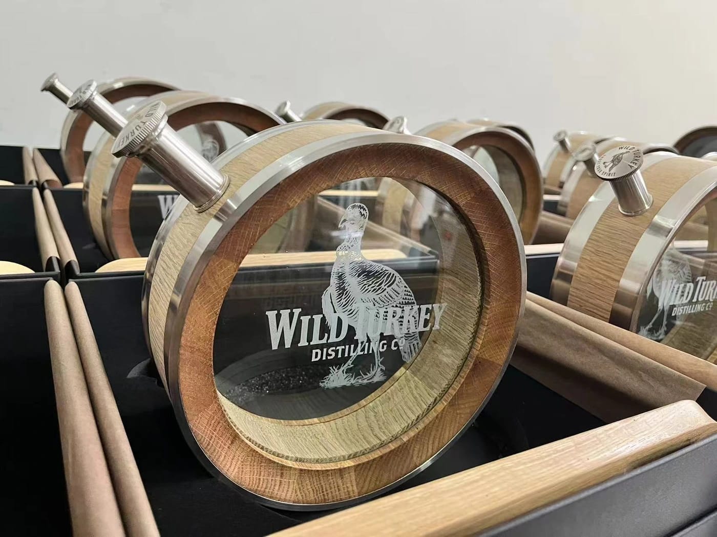 Wild Turkey — Engraved glass branding across a collection of oak decanters
