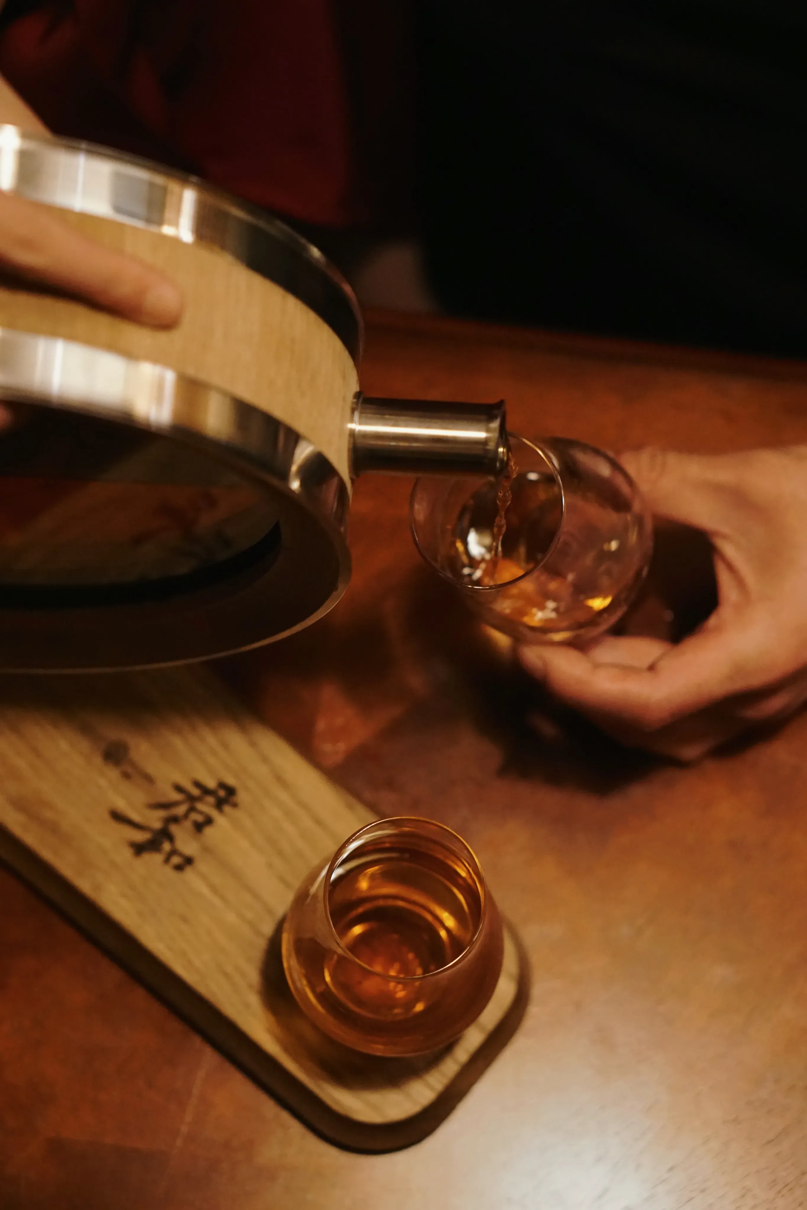 Pouring spirits from the 500ml oak barrel