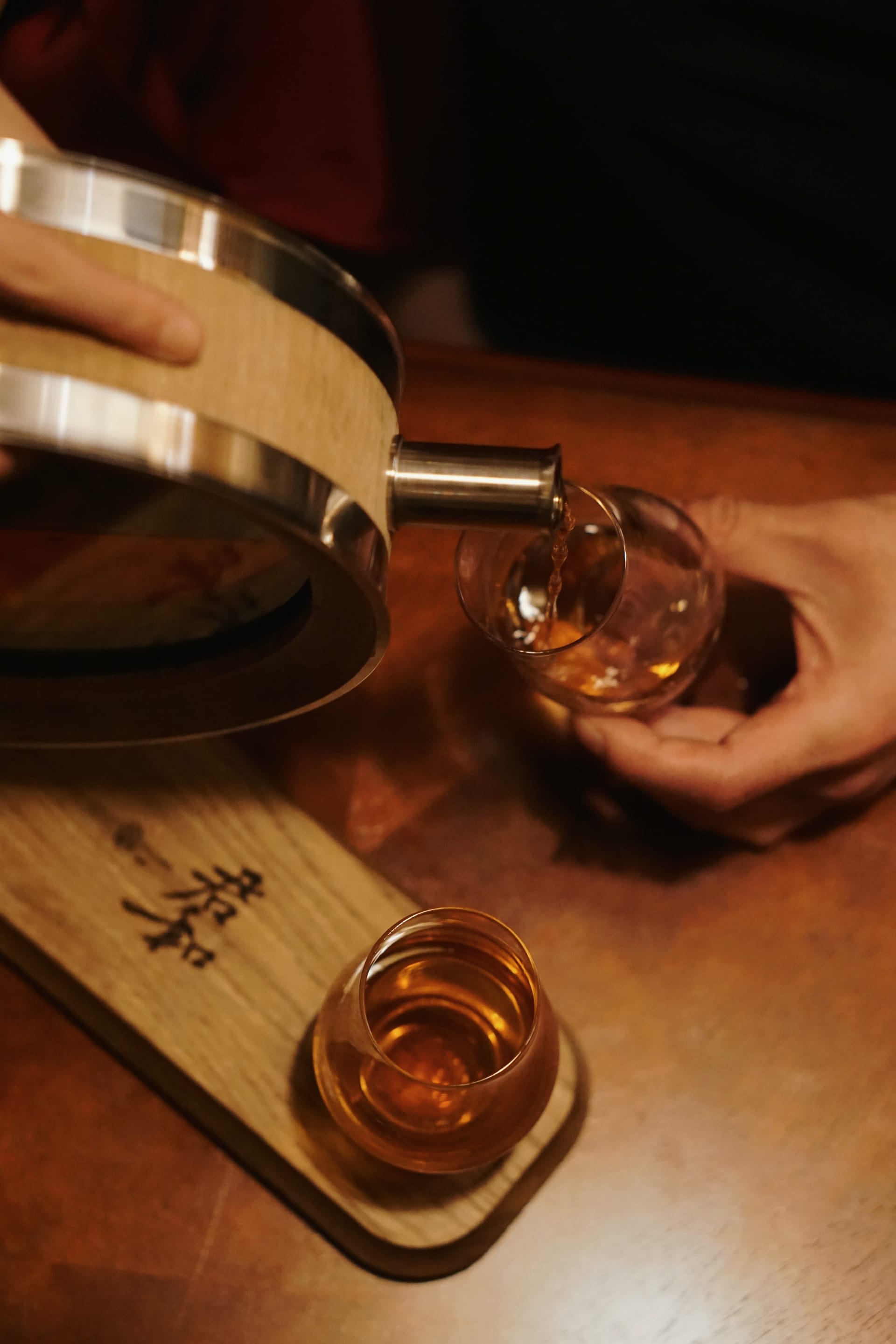 Pouring spirits from the 500ml oak barrel