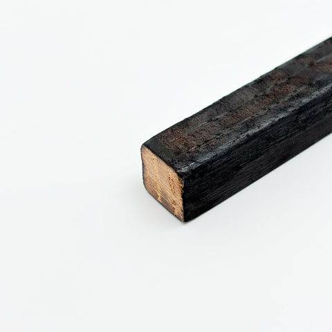 A detailed picture of a charred oak stick.