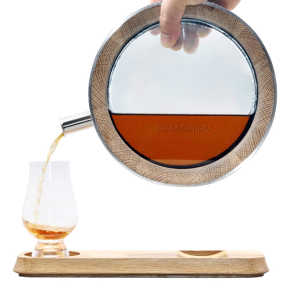 The 700ml oak barrel decanter is pouring the aged whiskey into the glass.