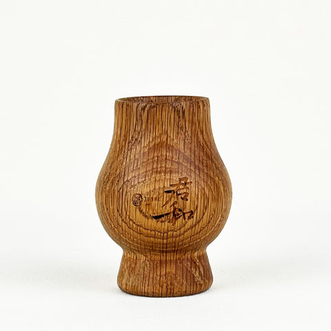 An oak whiskey tumbler with the logo of Junhe Supply.