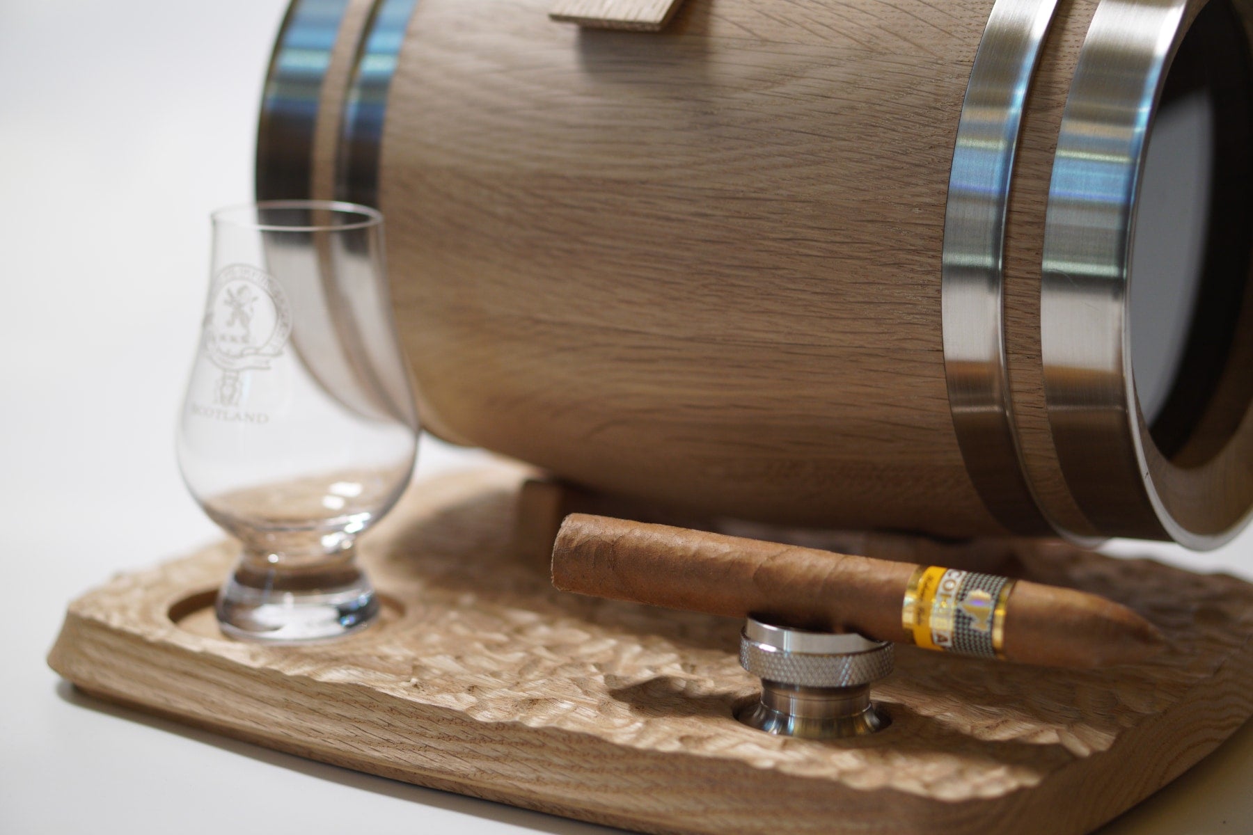 The stainless steel barrel band and the rippled oak base of the personalized mini oak whiskey barrel.