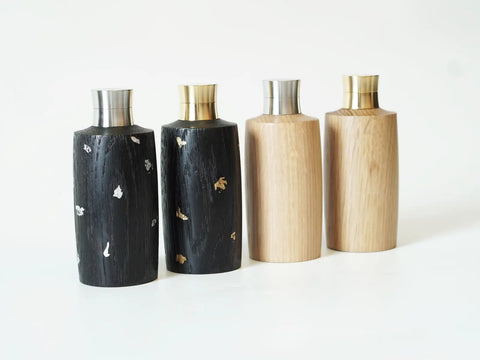 Four outdoor travel  bottles are placed together.